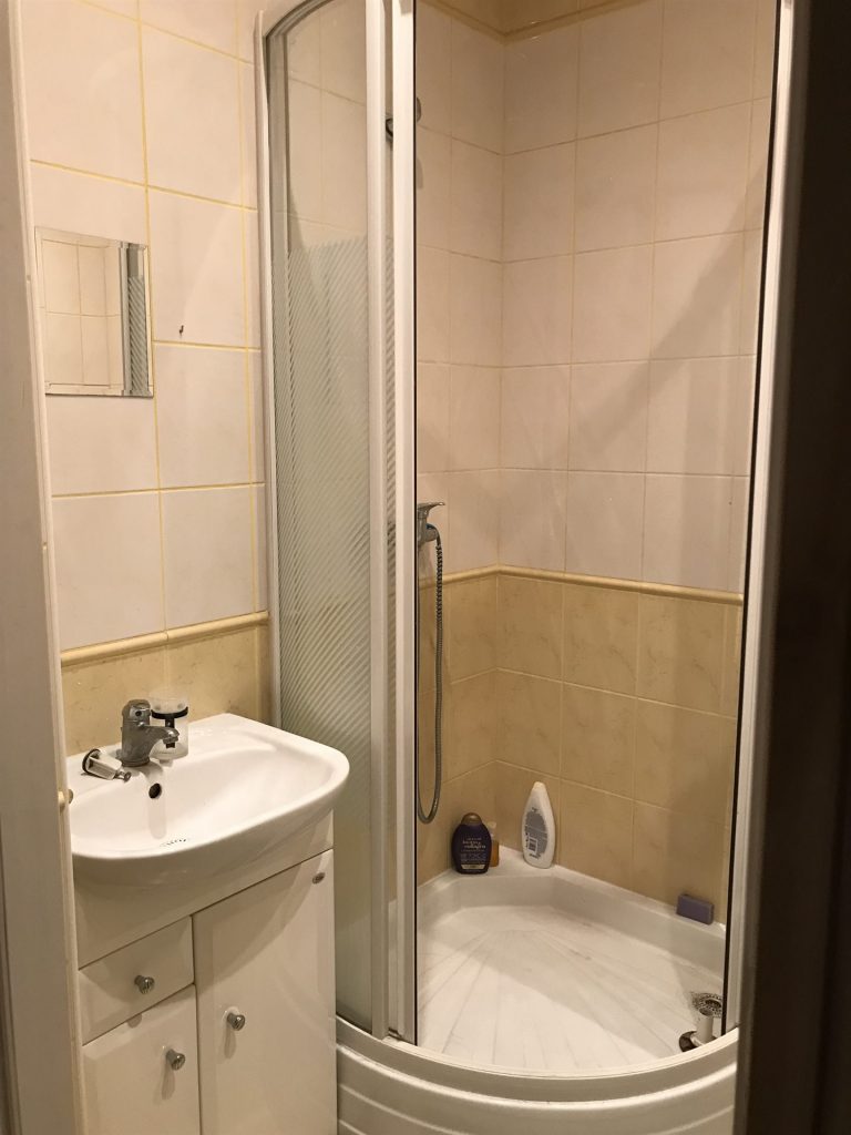 Mała łazienka w mikroapartamencie przed home stagingiem w Warszawie